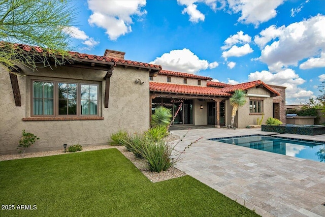 37440 N 104th Pl, Scottsdale, AZ 85262 - back of property with a patio area, a lawn, a chimney, stucco siding, and a jacuzzi