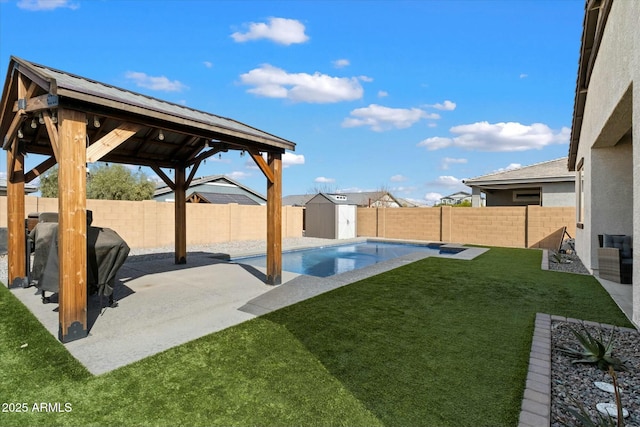 view of yard featuring a fenced in pool, a patio, and a storage shed