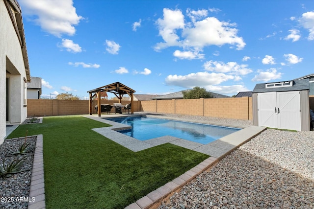 view of swimming pool with a gazebo, a yard, and a storage shed