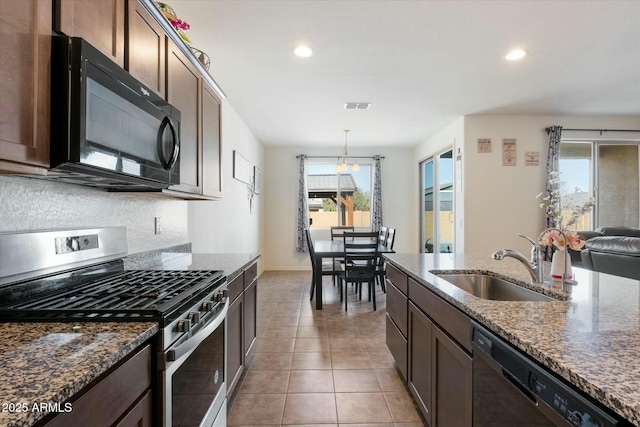 kitchen with sink, tile patterned flooring, hanging light fixtures, dark brown cabinets, and black appliances