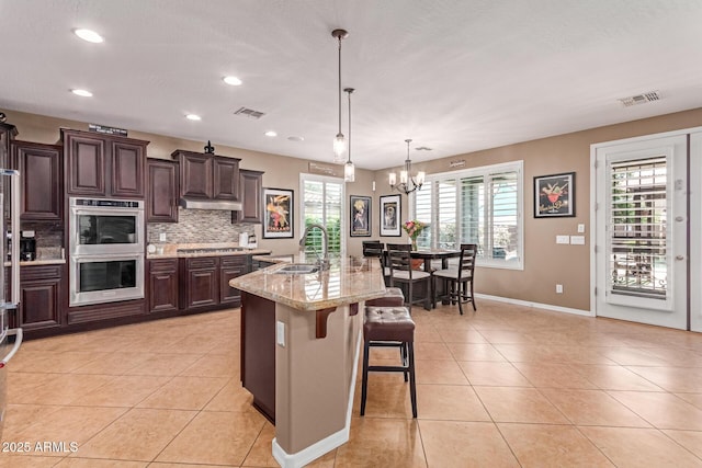 19427 W Colter St, Litchfield Park, AZ 85340 - kitchen featuring appliances with stainless steel finishes, a sink, light tile patterned floors, backsplash, and recessed lighting