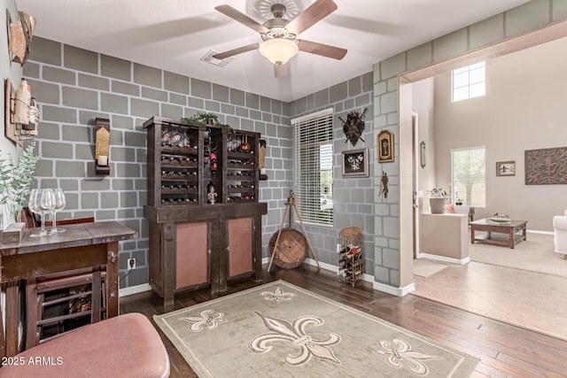 19427 W Colter St, Litchfield Park, AZ 85340 - wine room featuring hardwood / wood-style flooring, baseboards, ceiling fan, and an accent wall