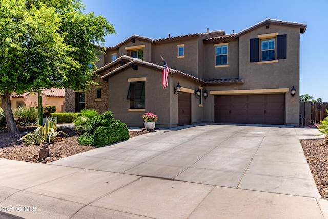 19427 W Colter St, Litchfield Park, AZ 85340 - mediterranean / spanish-style house with stucco siding, a tiled roof, an attached garage, and concrete driveway
