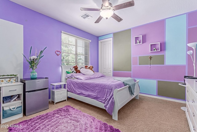 19427 W Colter St, Litchfield Park, AZ 85340 - carpeted bedroom featuring freestanding refrigerator, a closet, and a ceiling fan