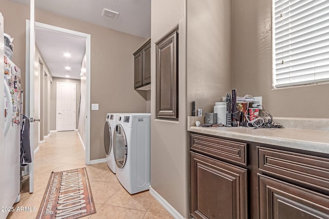 19427 W Colter St, Litchfield Park, AZ 85340 - washroom featuring cabinet space, independent washer and dryer, light tile patterned flooring, and baseboards