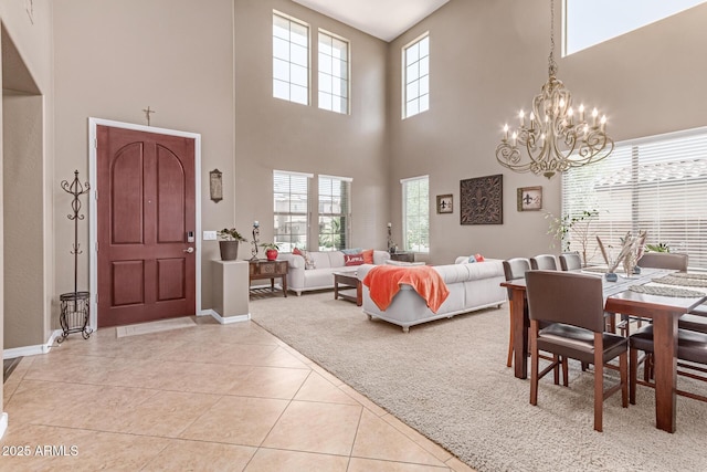 19427 W Colter St, Litchfield Park, AZ 85340 - entryway with a towering ceiling, light tile patterned floors, a chandelier, and baseboards