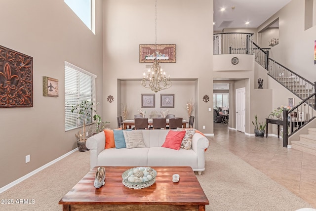 19427 W Colter St, Litchfield Park, AZ 85340 - carpeted living area featuring a chandelier, a high ceiling, stairs, baseboards, and tile patterned flooring