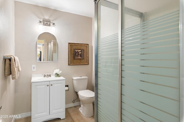 bathroom featuring tile patterned floors, vanity, toilet, and an enclosed shower