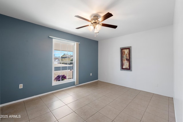 tiled empty room featuring ceiling fan