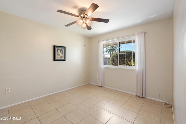 spare room featuring light tile patterned floors and ceiling fan