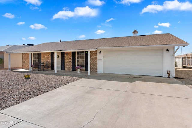 ranch-style house with a porch and a garage