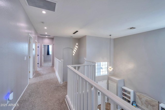 2210 W Goldmine Mountain Dr, Queen Creek, AZ 85144 - hall with light carpet, visible vents, baseboards, and an upstairs landing