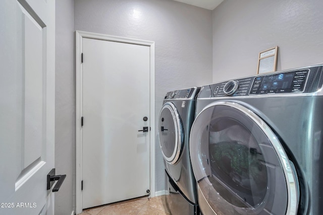 2210 W Goldmine Mountain Dr, Queen Creek, AZ 85144 - washroom with light tile patterned flooring, laundry area, and washing machine and clothes dryer
