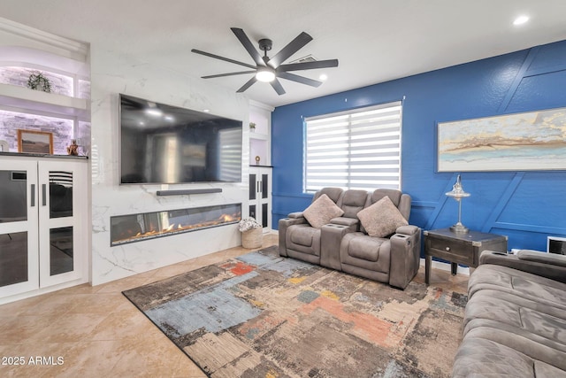 2210 W Goldmine Mountain Dr, Queen Creek, AZ 85144 - living room featuring a decorative wall, a ceiling fan, and a fireplace