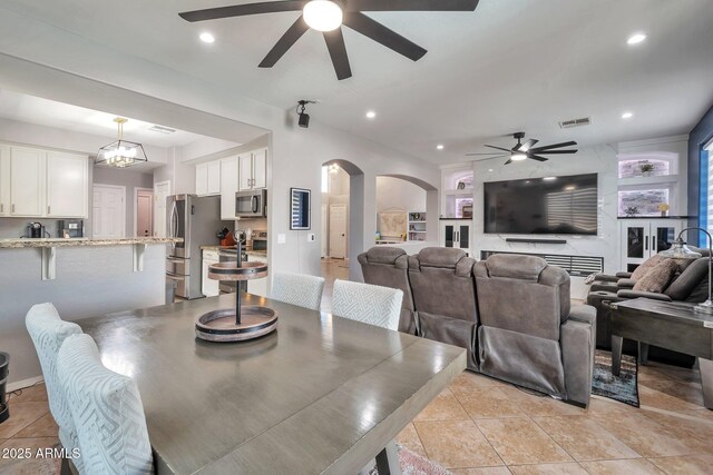 2210 W Goldmine Mountain Dr, Queen Creek, AZ 85144 - dining area with recessed lighting, light tile patterned floors, a ceiling fan, visible vents, and arched walkways