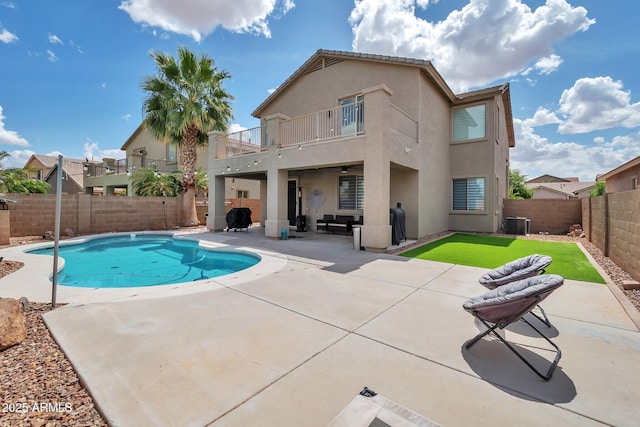 2210 W Goldmine Mountain Dr, Queen Creek, AZ 85144 - rear view of property with a fenced backyard, a patio, a balcony, stucco siding, and a fenced in pool