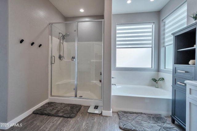 2210 W Goldmine Mountain Dr, Queen Creek, AZ 85144 - bathroom with a bath, baseboards, a stall shower, and wood finished floors