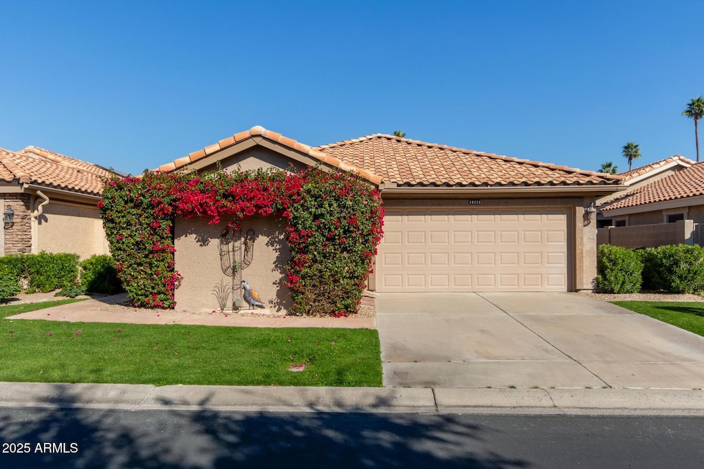 mediterranean / spanish house with a garage