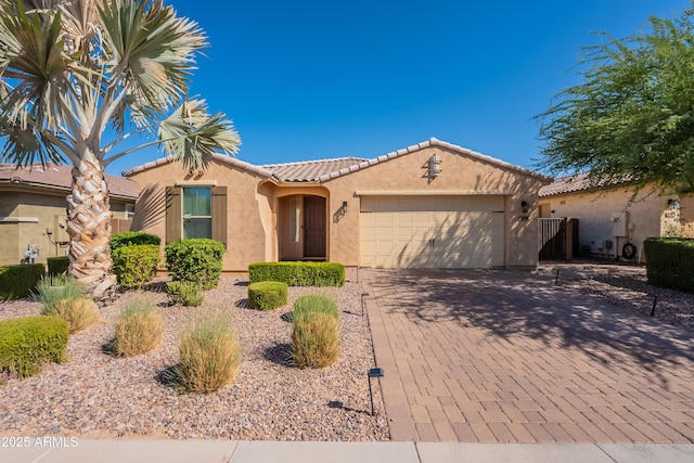 2680 E Daniel Dr, Gilbert, AZ 85298 - mediterranean / spanish house featuring stucco siding, a garage, decorative driveway, and a tiled roof