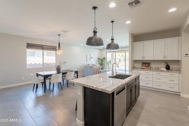 2680 E Daniel Dr, Gilbert, AZ 85298 - kitchen with dishwasher, recessed lighting, decorative light fixtures, white cabinetry, and a center island with sink