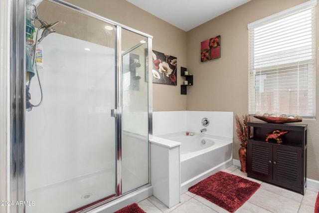 bathroom with tile patterned floors and independent shower and bath