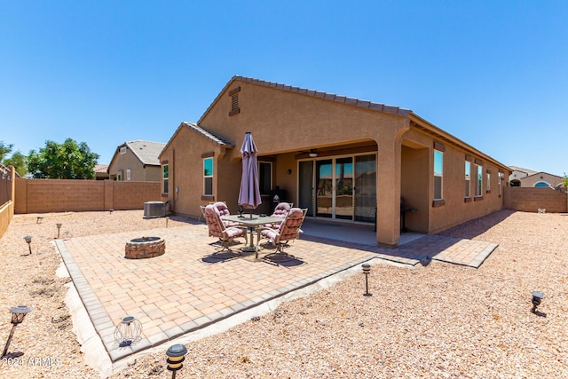 rear view of house with a fire pit, ceiling fan, a patio area, and central air condition unit