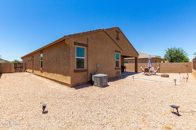 back of property with a patio and central AC unit