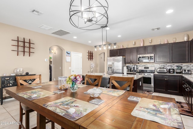 dining space featuring a chandelier and light tile patterned flooring