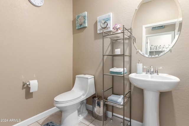 bathroom featuring tile patterned floors, toilet, and sink