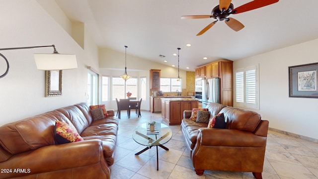 living room with a wealth of natural light, sink, ceiling fan, and vaulted ceiling