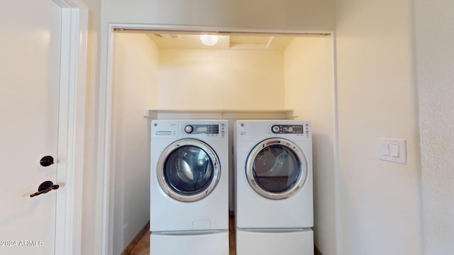 clothes washing area featuring washer and clothes dryer