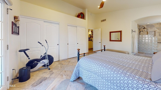 bedroom with ceiling fan and two closets