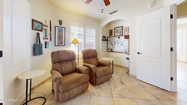 sitting room with ceiling fan and light tile patterned flooring