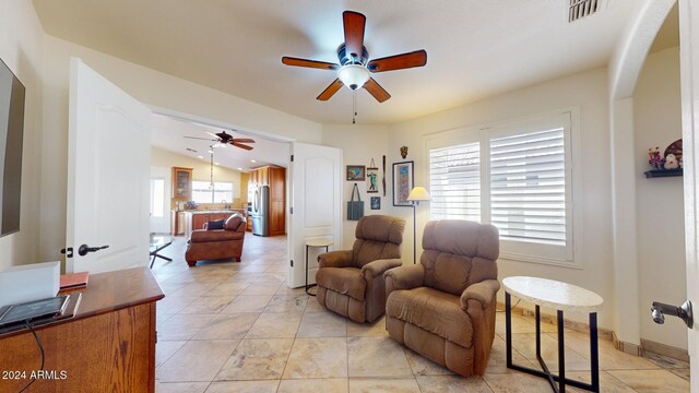 living room featuring ceiling fan and lofted ceiling