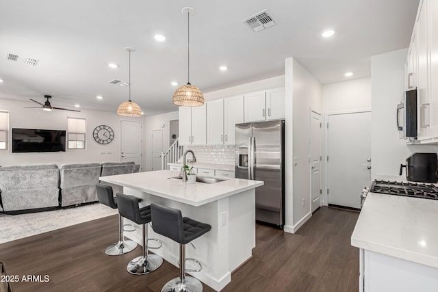 9901 E Tamery Ave, Mesa, AZ 85212 - kitchen with stainless steel appliances, a sink, dark wood-style flooring, white cabinetry, and recessed lighting
