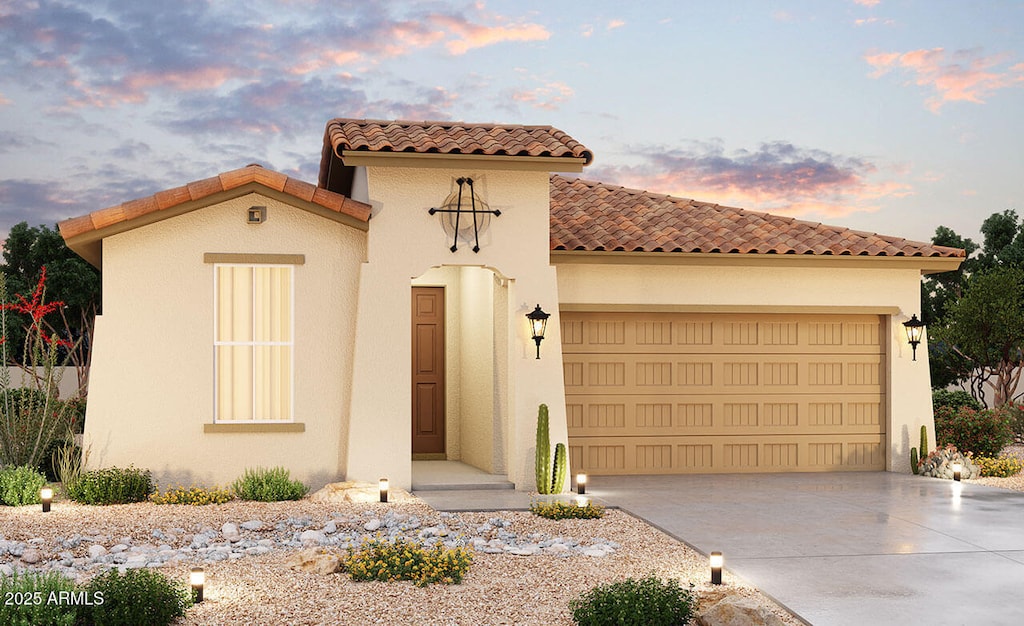 mediterranean / spanish-style house with a garage