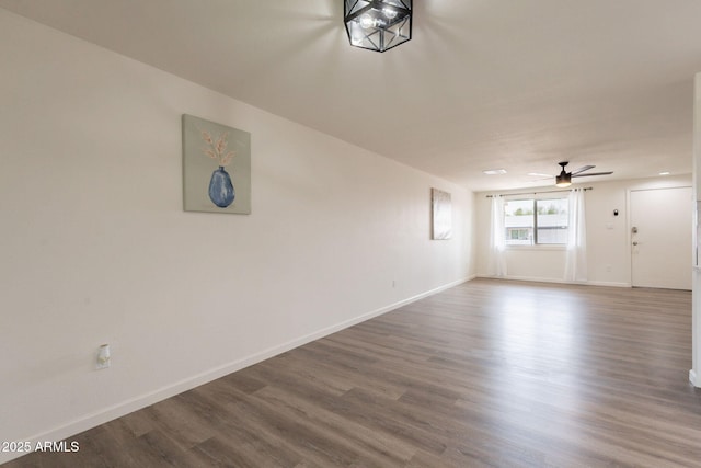3620 E Ludlow Dr, Phoenix, AZ 85032 - unfurnished living room with a ceiling fan, baseboards, and dark wood-type flooring