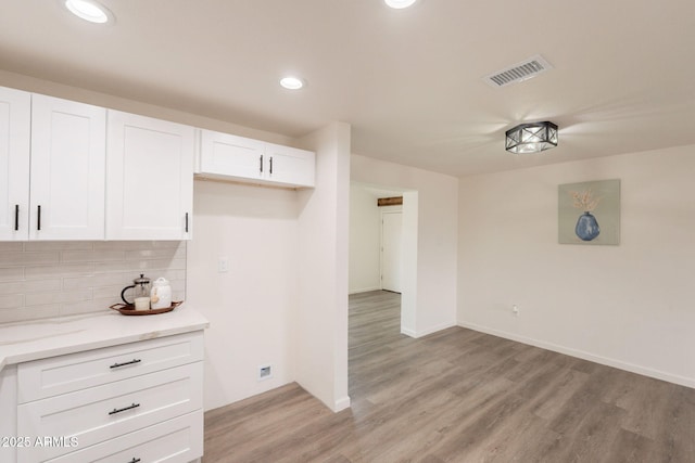 3620 E Ludlow Dr, Phoenix, AZ 85032 - kitchen with white cabinetry, light wood-style flooring, tasteful backsplash, recessed lighting, and light stone counters