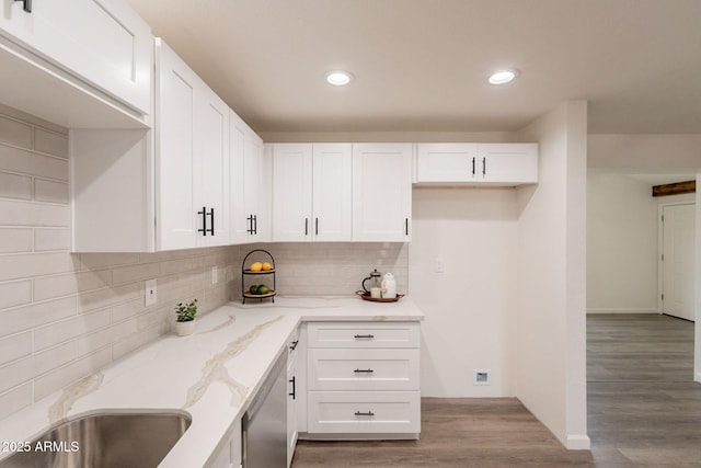 3620 E Ludlow Dr, Phoenix, AZ 85032 - kitchen with light stone countertops, dishwasher, light wood-style flooring, white cabinets, and backsplash