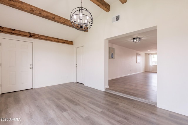 3620 E Ludlow Dr, Phoenix, AZ 85032 - spare room featuring a chandelier, wood finished floors, and baseboards