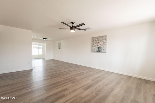 3620 E Ludlow Dr, Phoenix, AZ 85032 - unfurnished room featuring wood finished floors, ceiling fan, and baseboards