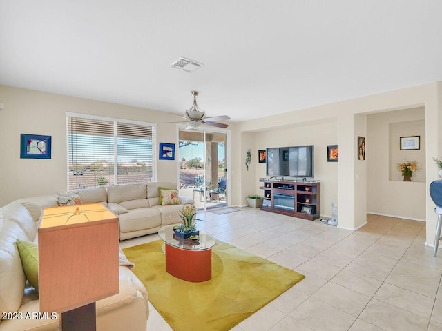 tiled living room with ceiling fan