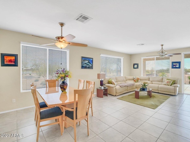 tiled dining space with ceiling fan