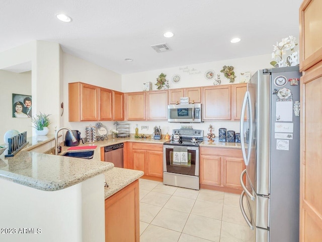 kitchen with kitchen peninsula, sink, light stone countertops, appliances with stainless steel finishes, and light tile patterned flooring