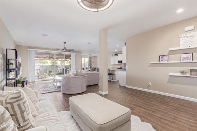 living room with ceiling fan and wood-type flooring