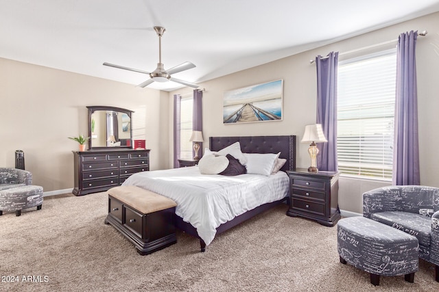 bedroom with carpet floors, multiple windows, and ceiling fan