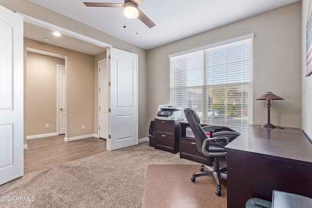 office with ceiling fan and light wood-type flooring