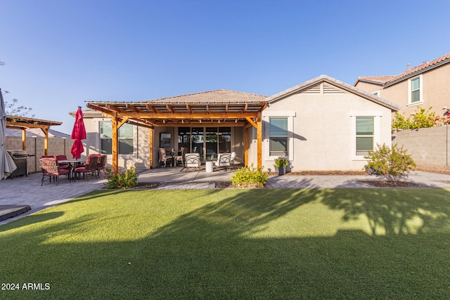 rear view of property featuring a pergola, a patio area, and a yard