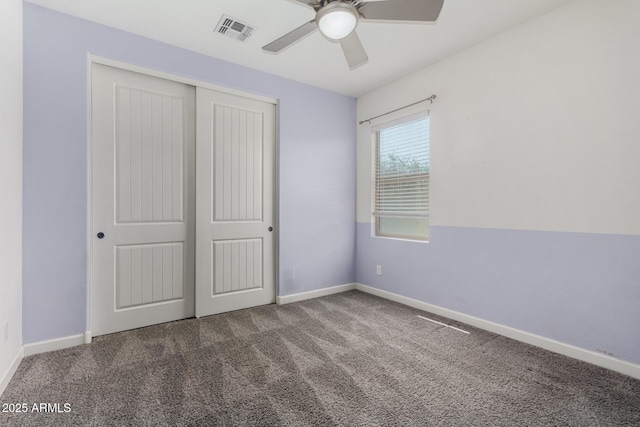 unfurnished bedroom with visible vents, ceiling fan, baseboards, carpet, and a closet