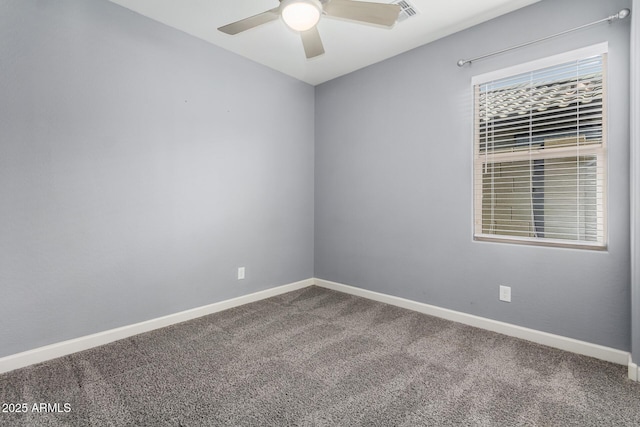 empty room featuring carpet flooring, baseboards, and a ceiling fan